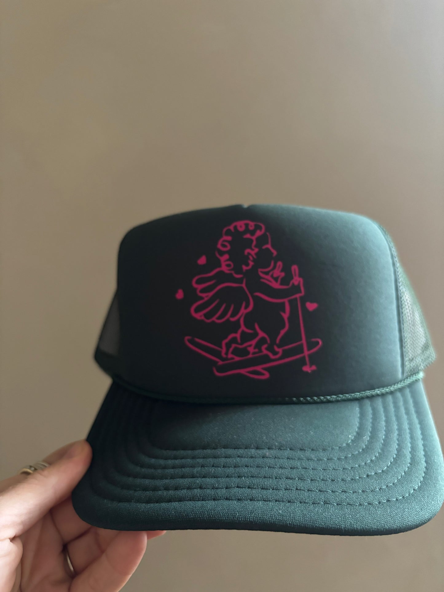 Skiing Cherub - Dark Green Foam Trucker Hat